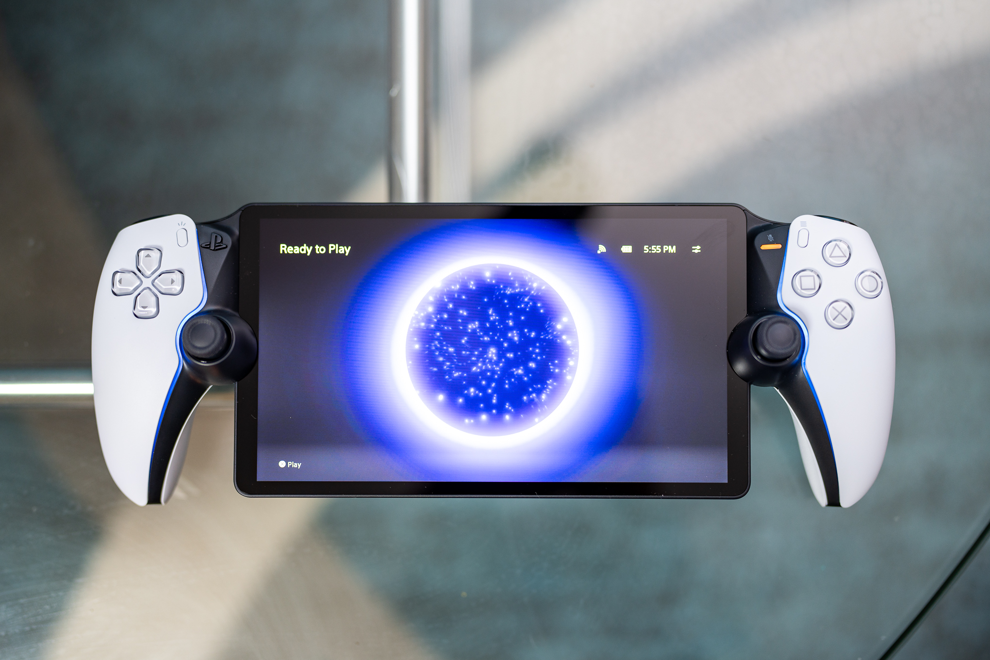 Futuristic design of the PlayStation Portal console showcasing its cloud gaming features with PS5 and digital game elements.