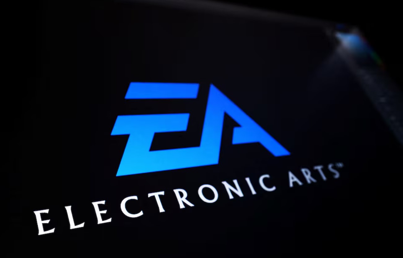 Dramatic artwork showing tension in the gaming industry with EA's logo overshadowed by a businessman, representing international corporate acquisitions.