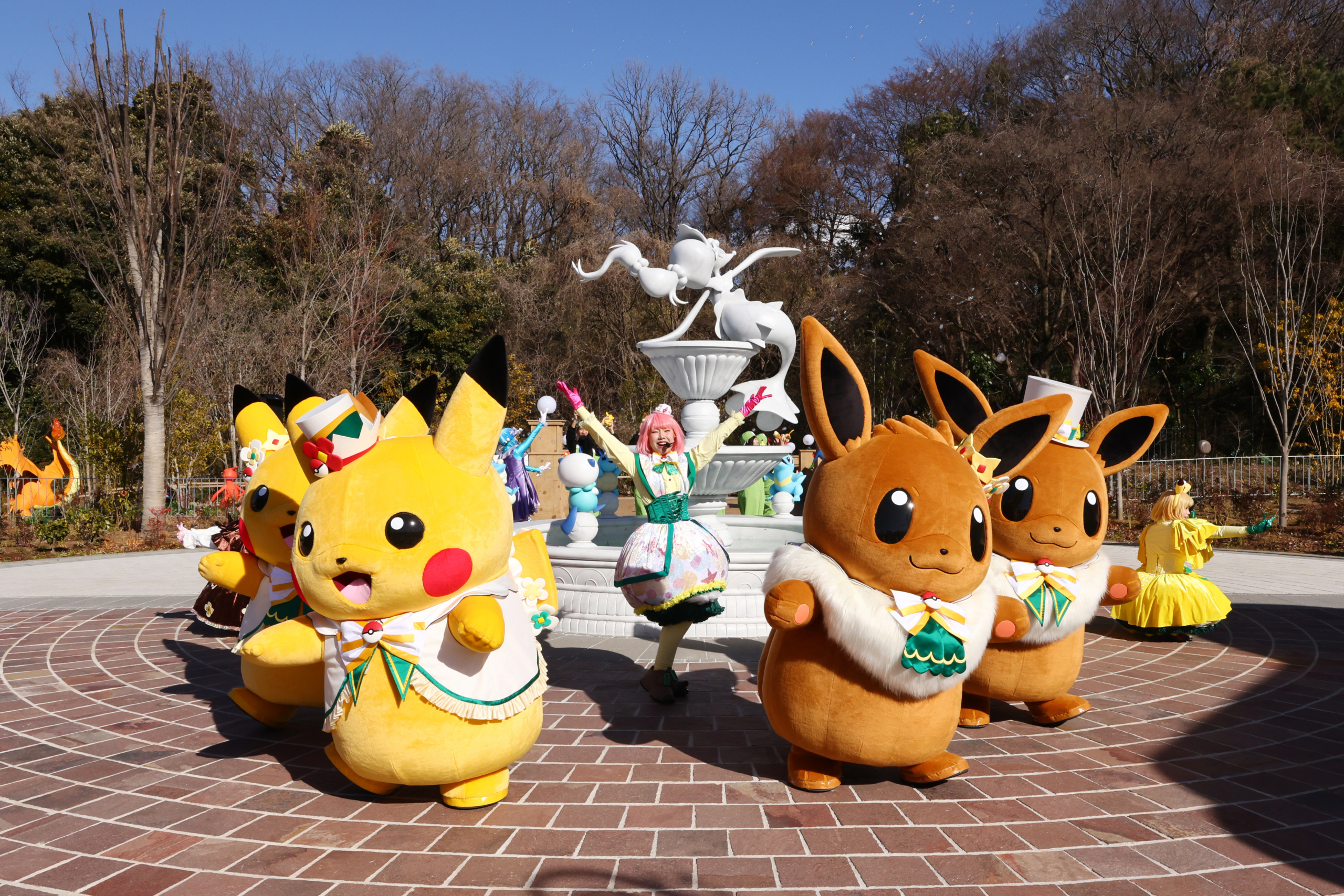 A vibrant scene from the grand opening of PokePark Kanto in Japan featuring fans interacting with Pok&eacute;mon, Pok&eacute;mon battles, and iconic Pok&eacute;mon characters.