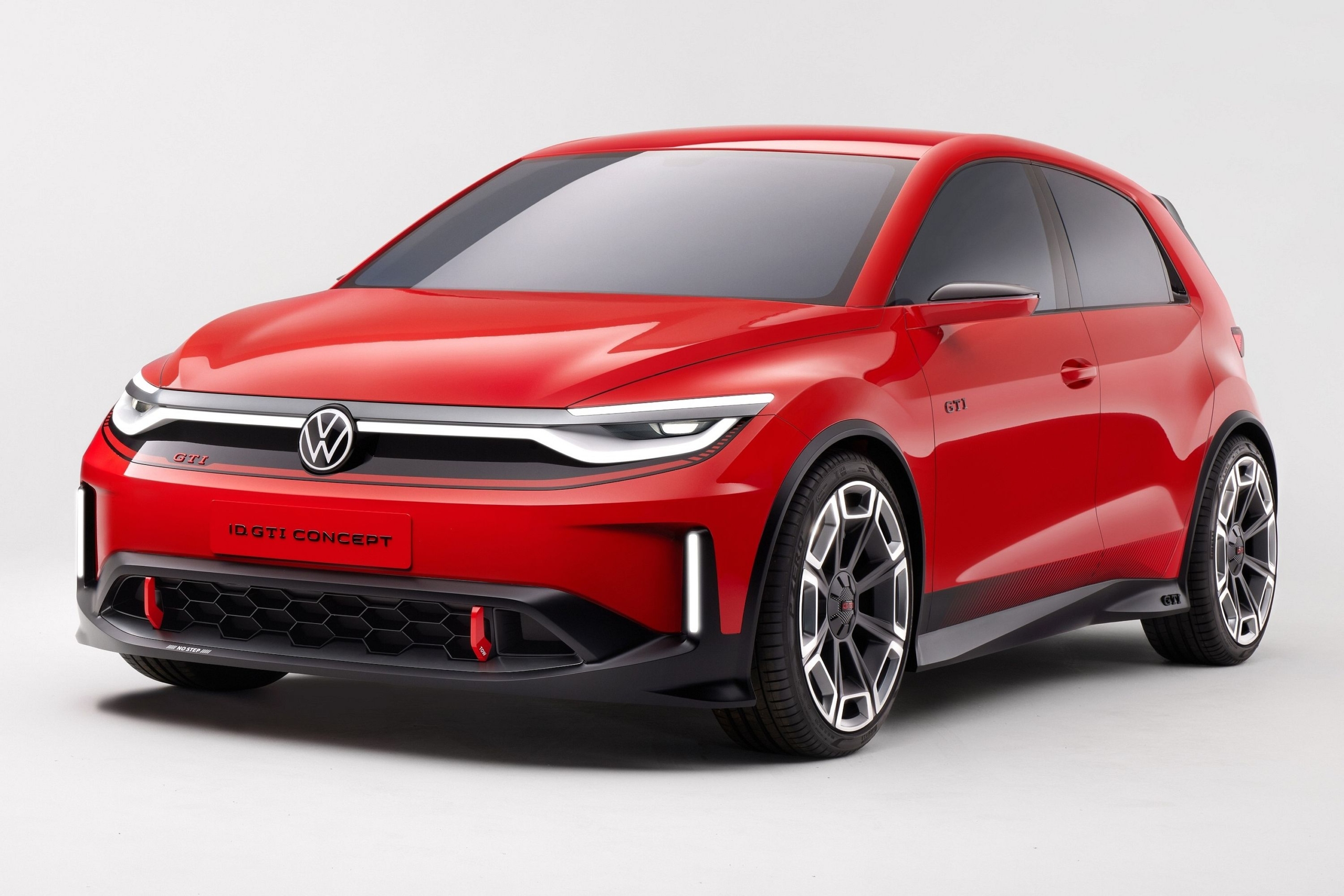 Futuristic electric Volkswagen Golf in an urban setting showcasing its modern design and high-tech interior.