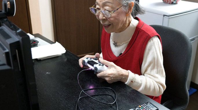 A 91-year-old woman playing video games while police officers look on in confusion.