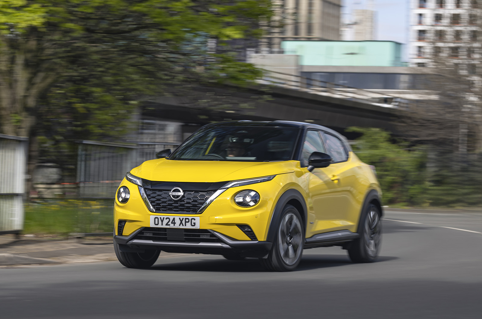A promotional scene of the new Nissan Juke and X-Trail e-Power showcased in a modern urban setting during a launch event.